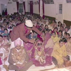 [Photo of Keher Singh, an unidentified bride and the wedding guests]