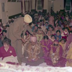 [Photo of Surinder Gill and wedding guests]