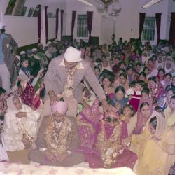 [Photo of the wedding guests in the Gurdwara facing the Granthi]