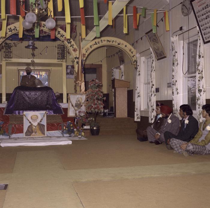 [Photo of unidentified men in the Gurdwara Prayer Room]