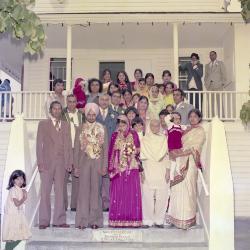 [Photo of Gurmeet Singh and Paramjit Kaur with their wedding guests on the gurdwara steps]