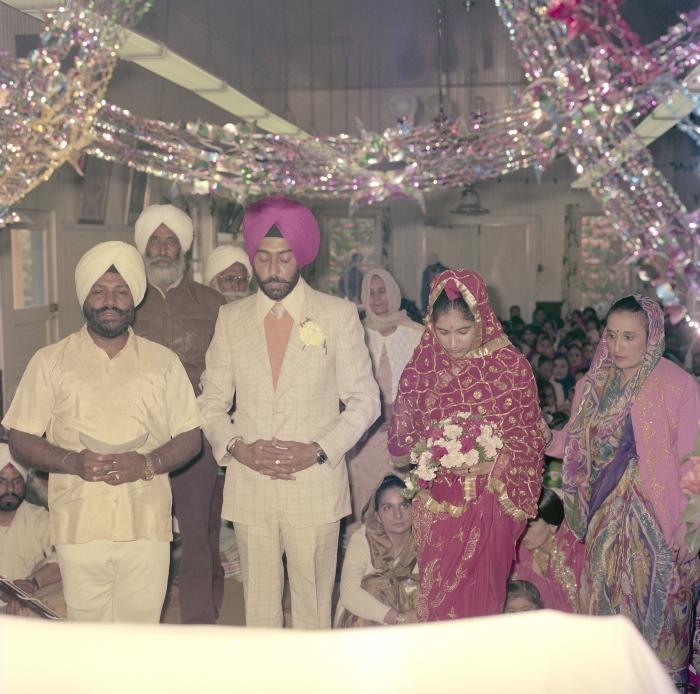 [Photo of Shinder Sandhu, Jaswant Gill and their wedding guests]