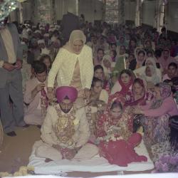 [Photo of Kapoor Singh, an unidentified bride and wedding guests on the steps of the Gurdwara]