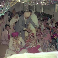 [Photo of Kapoor Singh, an unidentified bride and wedding guests on the steps of the Gurdwara]