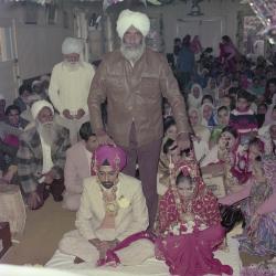 [Photo of Kapoor Singh, an unidentified bride and weddings guests]