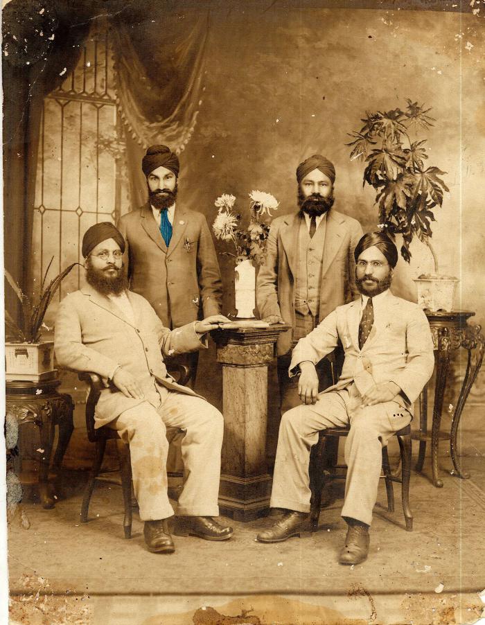 [Family portrait of four men]