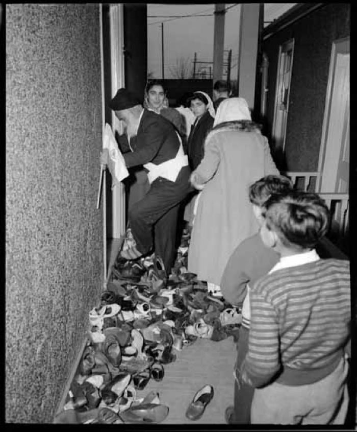 Group of worshippers taking off their shoes at the Sikh Temple during a visit by Jawaharlal Nehru