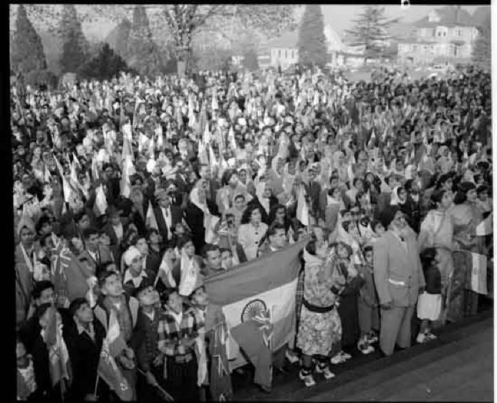Crowd with flags greeting Jawaharlal Nehru (off camera) outside the Sikh temple