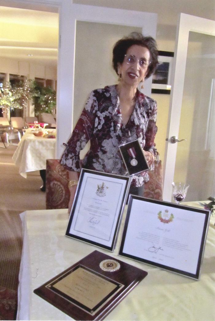 [Photo of Banto Gill with her awards]