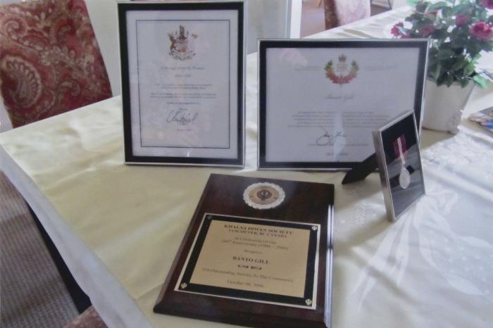 [Photo of four awards awarded to Banto Gill]