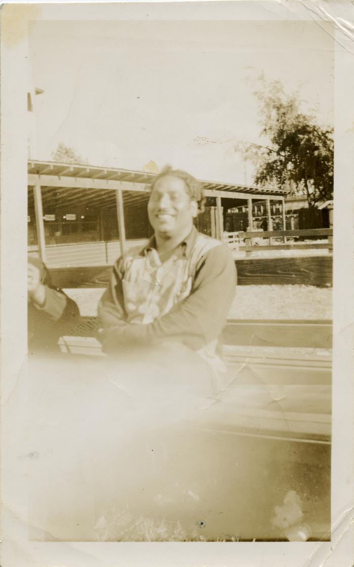 [Photo of Phangan Singh Gill sitting on a bench at the Brighouse Racetrack]