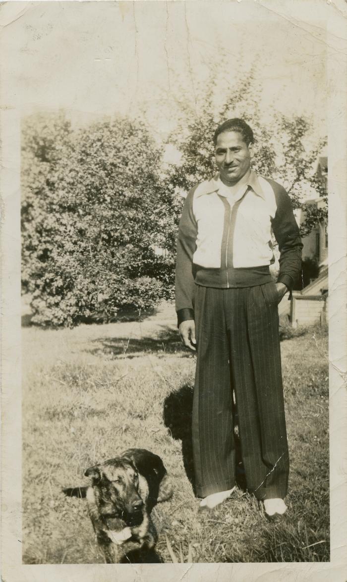 [Photo of Phangan Singh Gill with his dog]