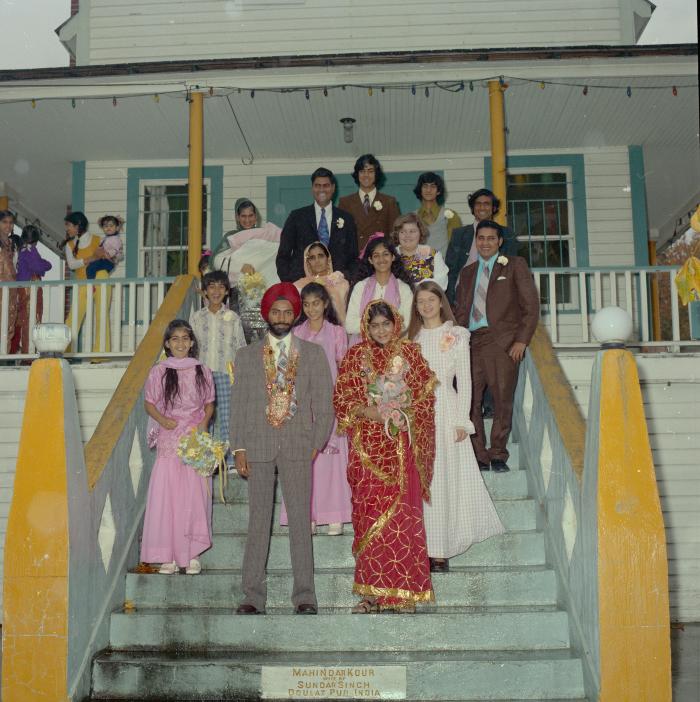 [Photo of Gurdev S. Brar, and unidentified bride and wedding guests on the Gurdwara steps]