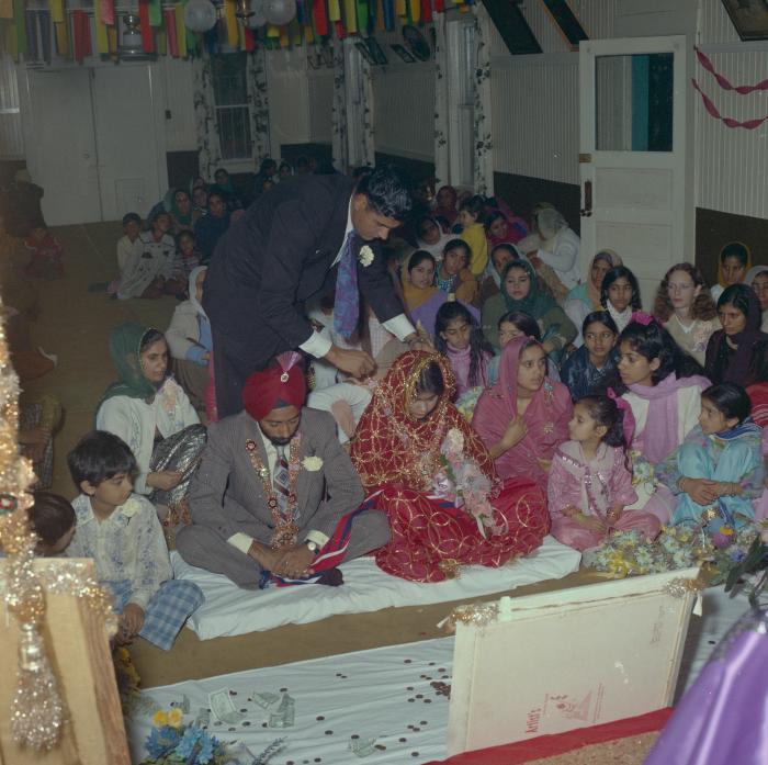 [Photo of Gurdev S. Brar, and unidentified bride and wedding guests]