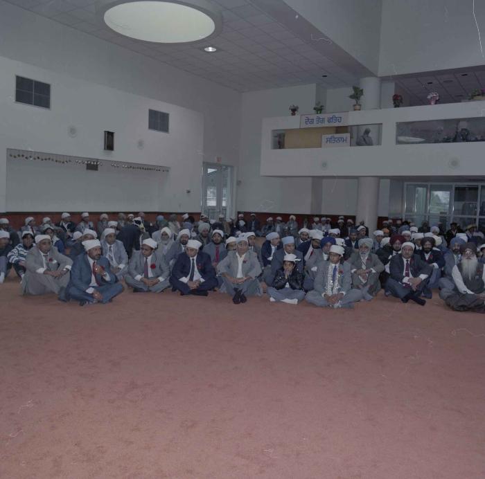 [Photo of Manpreet Brar and unidentified group of men]
