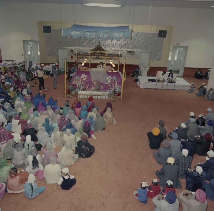 [Photo of the wedding guests in the Gurdwara facing the Granthi]