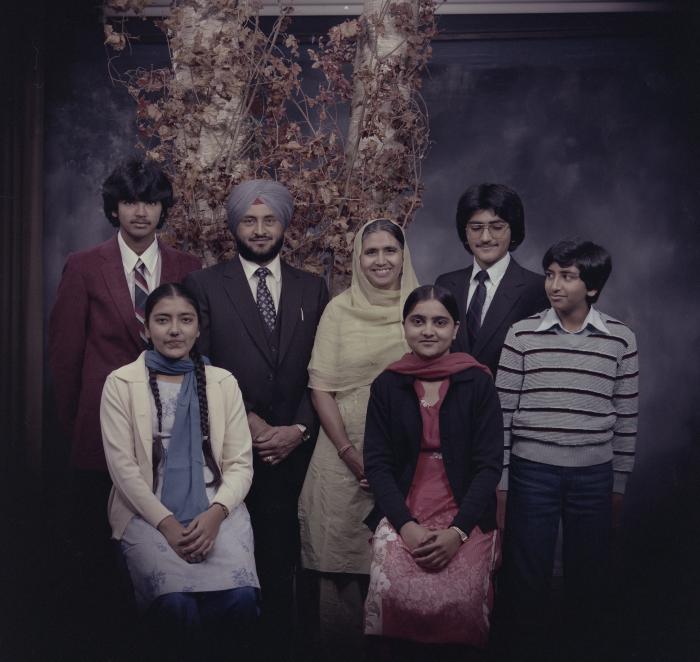 [Group portrait of Harcharan Brar, three unidentified women and three unidentified men]
