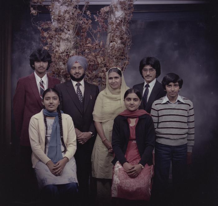 [Group portrait of Harcharan Brar, three unidentified women and three unidentified men]