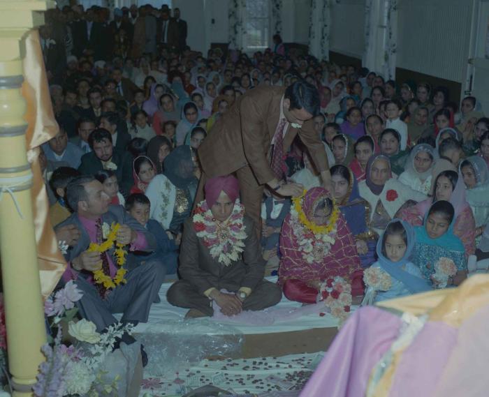 [Photo of H.S. Dhaliwal, an unidentified bride and wedding guests]