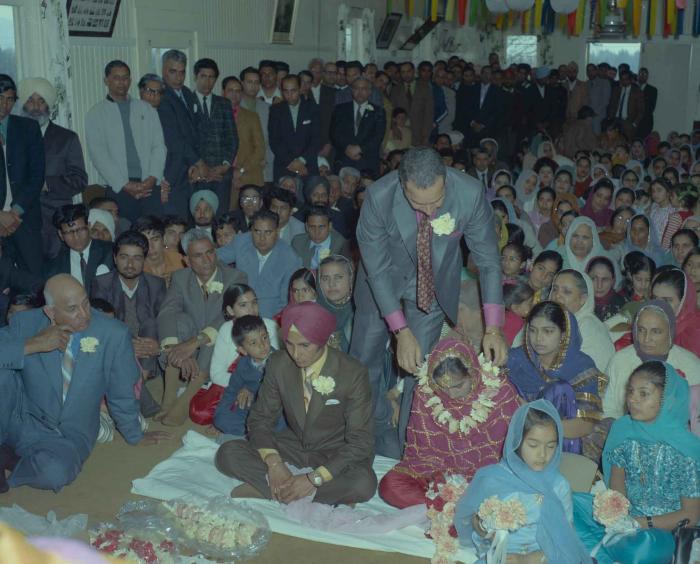 [Photo of H.S. Dhaliwal, an unidentified bride and wedding guests]