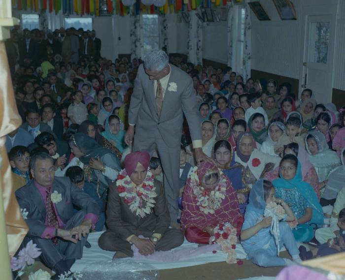 [Photo of H.S. Dhaliwal, an unidentified bride and wedding guests]
