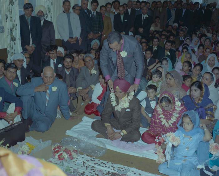 [Photo of H.S. Dhaliwal, an unidentified bride and wedding guests]