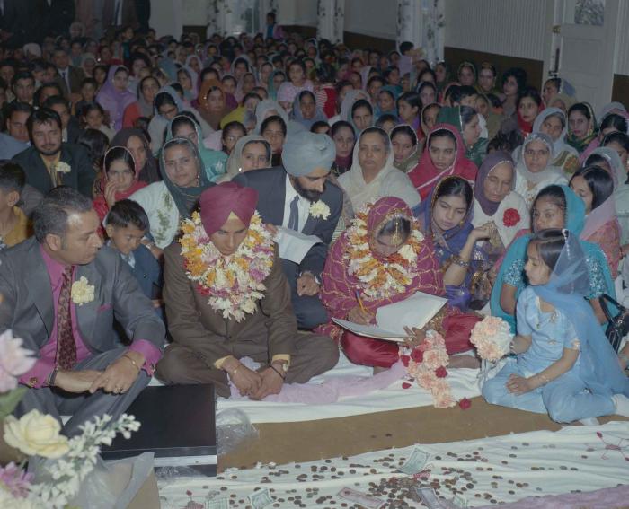 [Photo of H.S. Dhaliwal, an unidentified bride and wedding guests]