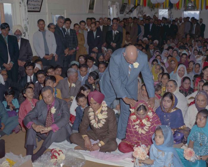 [Photo of H.S. Dhaliwal, an unidentified bride and wedding guests]