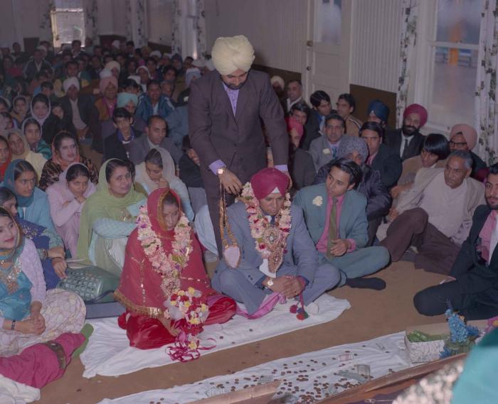 [Photo of Daljit Dhaliwal, an unidentified bride and wedding guests]
