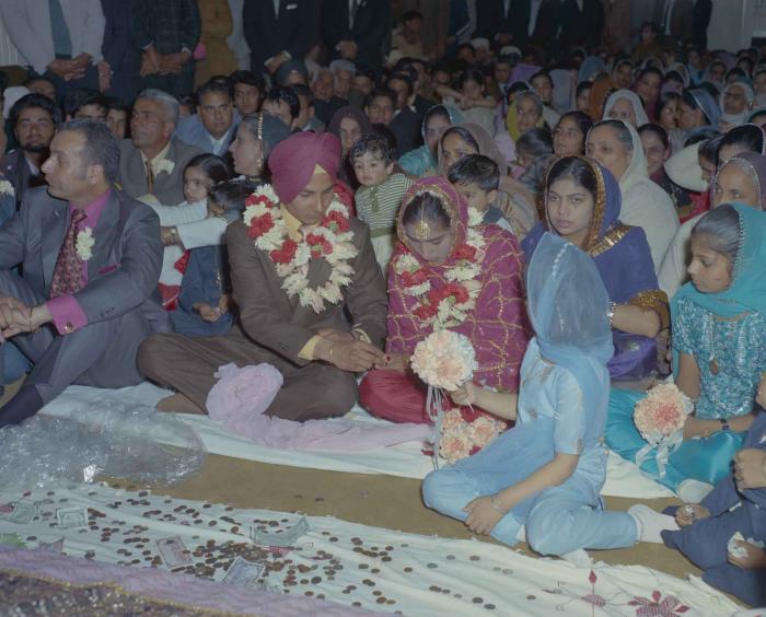 [Photo of H.S. Dhaliwal, an unidentified bride and wedding guests]
