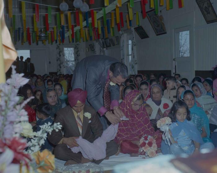 [Photo of H.S. Dhaliwal, an unidentified bride and wedding guests]