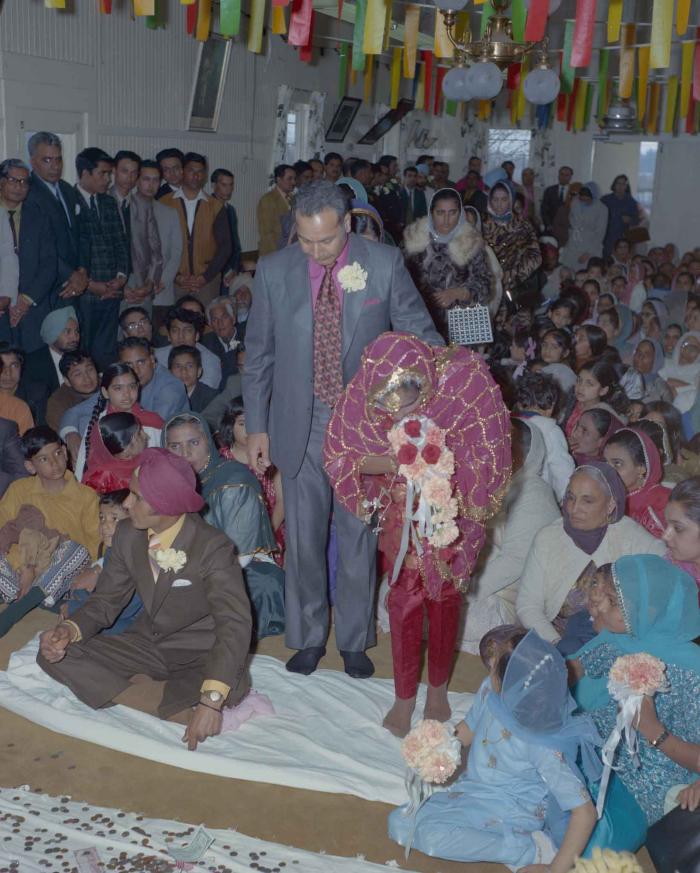 [Photo of H.S. Dhaliwal, an unidentified bride and wedding guests]