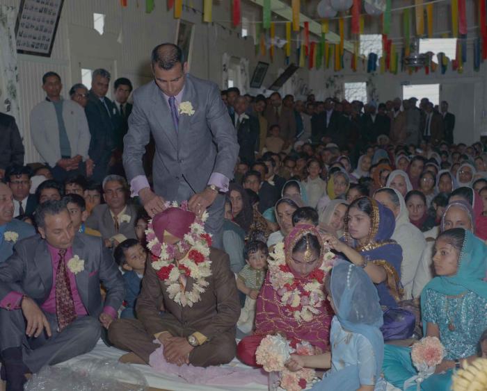 [Photo of H.S. Dhaliwal, an unidentified bride and wedding guests]