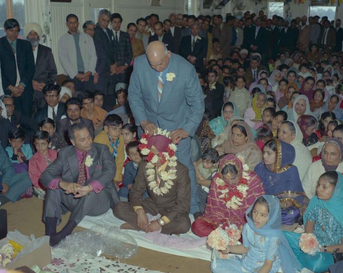 [Photo of H.S. Dhaliwal, an unidentified bride and wedding guests]