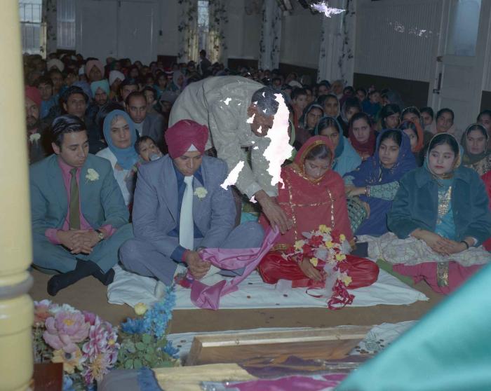 [Photo of Daljit Dhaliwal, an unidentified bride and wedding guests]