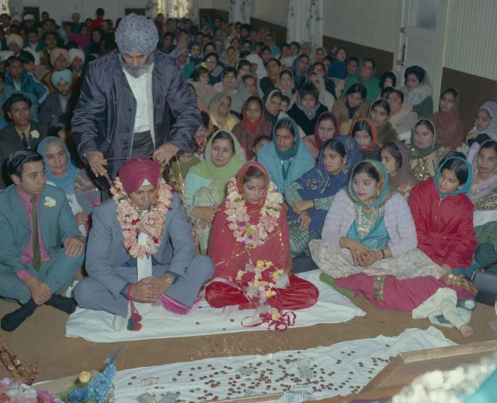 [Photo of Daljit Dhaliwal, an unidentified bride and wedding guests]