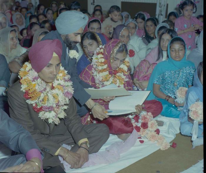 [Photo of H.S. Dhaliwal, an unidentified bride and wedding guests]