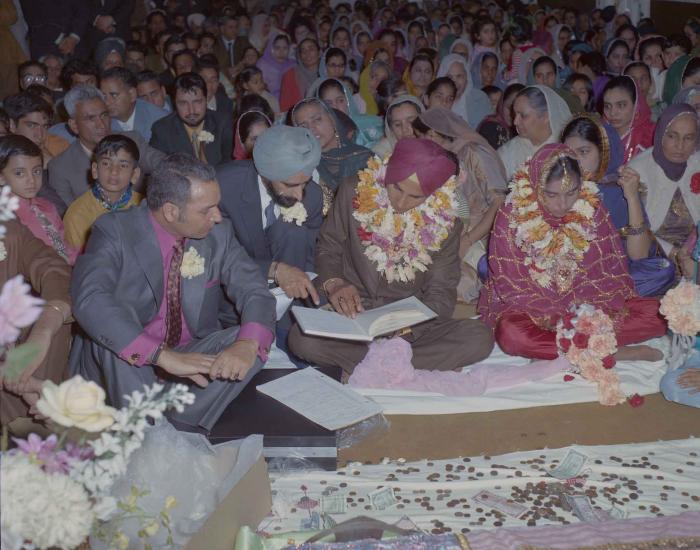[Photo of H.S. Dhaliwal, an unidentified bride and wedding guests]