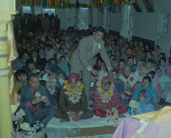 [Photo of H.S. Dhaliwal, an unidentified bride and wedding guests]