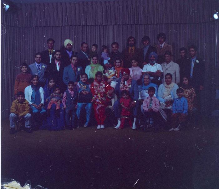 [Group portrait of Daljit Dhaliwal, an unidentified bride and wedding guests]