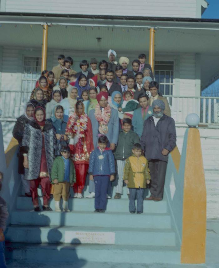 [Photo of Daljit Dhaliwal, an unidentified bride and wedding guests on the Gurdwara steps]