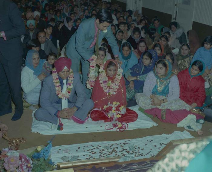 [Photo of Daljit Dhaliwal, an unidentified bride and wedding guests]