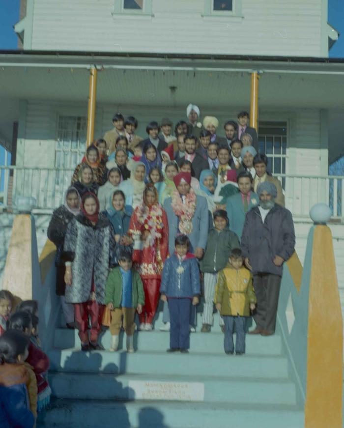 [Photo of Daljit Dhaliwal, an unidentified bride and wedding guests on the Gurdwara steps]