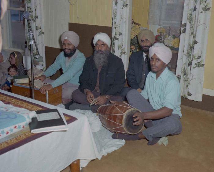 [Photo of four unidentified men in the Gurdwara]