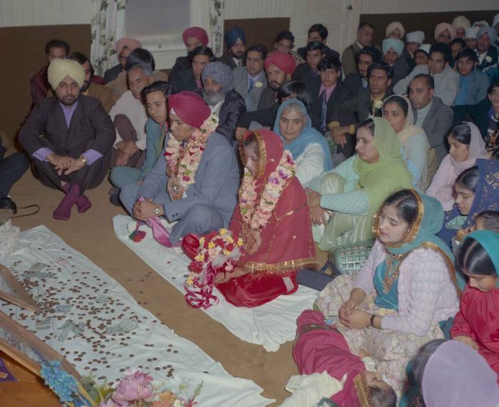 [Photo of Daljit Dhaliwal, an unidentified bride and wedding guests]