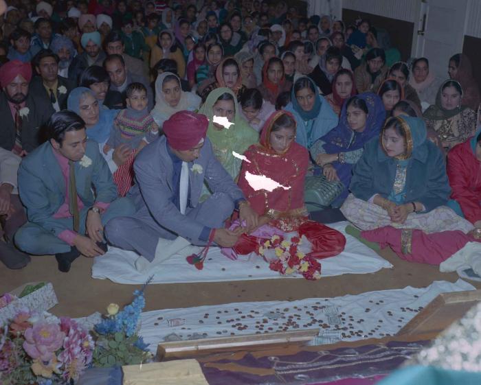 [Photo of Daljit Dhaliwal, an unidentified bride and wedding guests]
