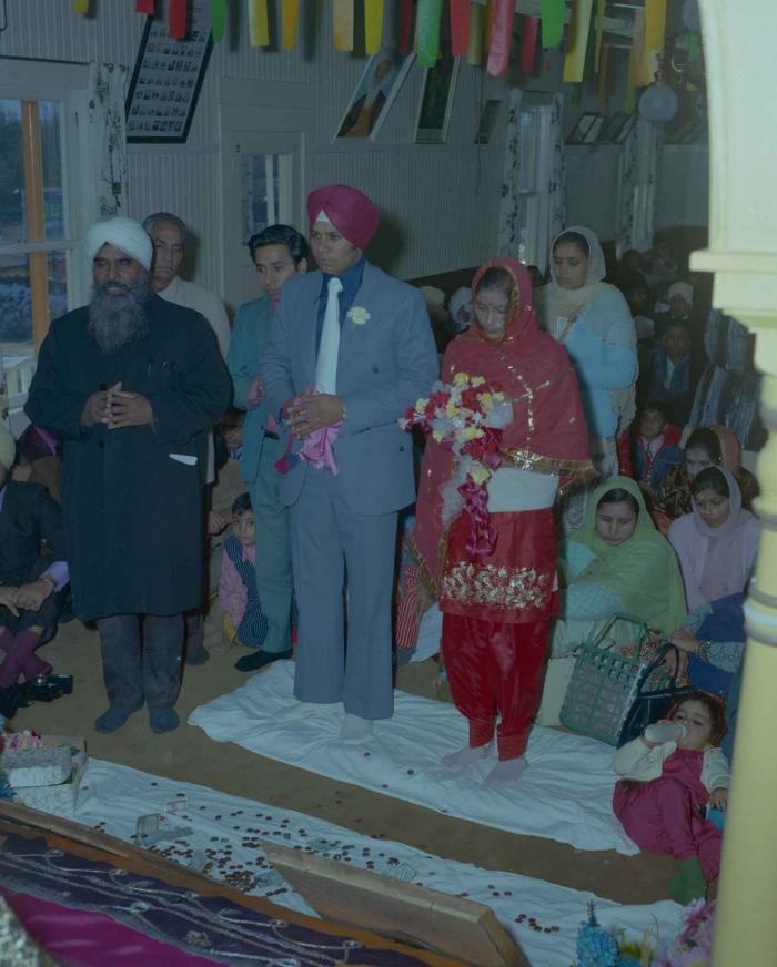 [Photo of Daljit Dhaliwal, an unidentified bride and wedding guests]