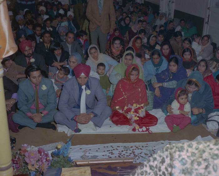 [Photo of Daljit Dhaliwal, an unidentified bride and wedding guests]