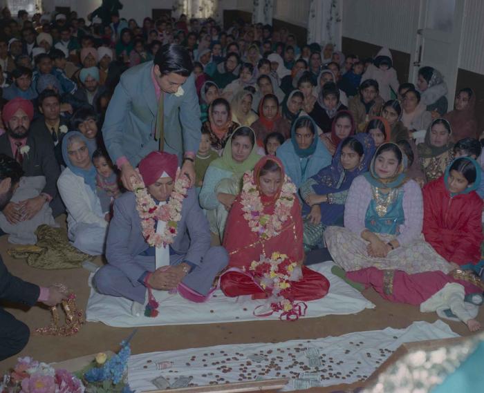 [Photo of Daljit Dhaliwal, an unidentified bride and wedding guests]