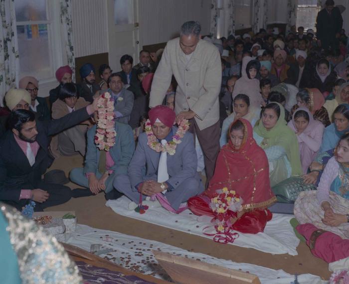 [Photo of Daljit Dhaliwal, an unidentified bride and wedding guests]